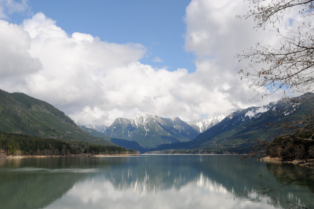 This is a  beautiful view of Spada Lake, east of Sultan, Washington, with cumulous clouds and a blue sky.