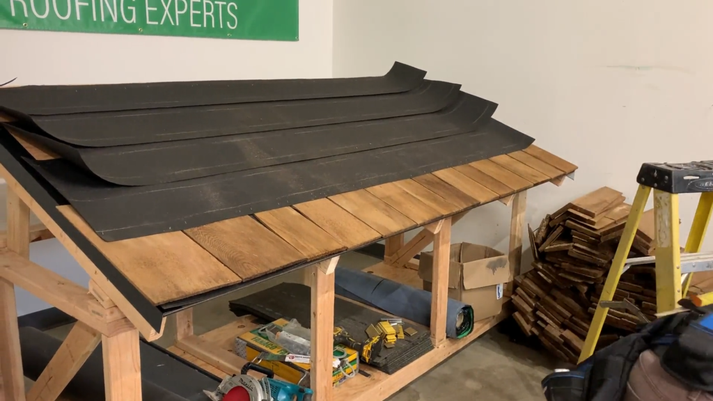 Photo of roofer installing the starter cedar shake shingles to make all the shingles the same height.