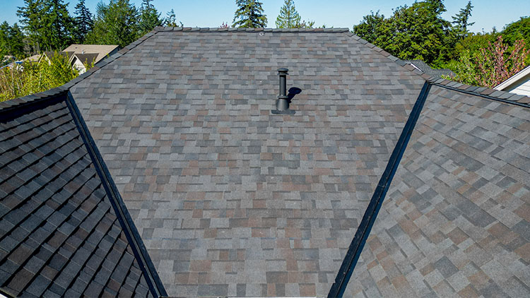 Closeup view of the roof valleys, shingles, and painted roof pipe to match the color of the New Composite Asphalt Shingle Roof in Maple Valley, Washington