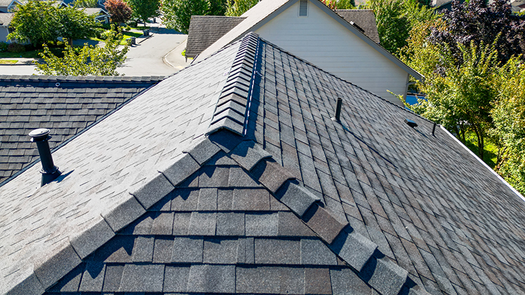 Closeup view of the ridge vent and shingles of the New Composite Asphalt Shingle Roof in Maple valley, Washington