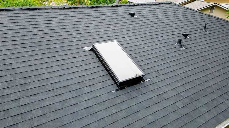 Closeup view with skylight of the New Composite Asphalt Shingle Roof home in Renton, Washington